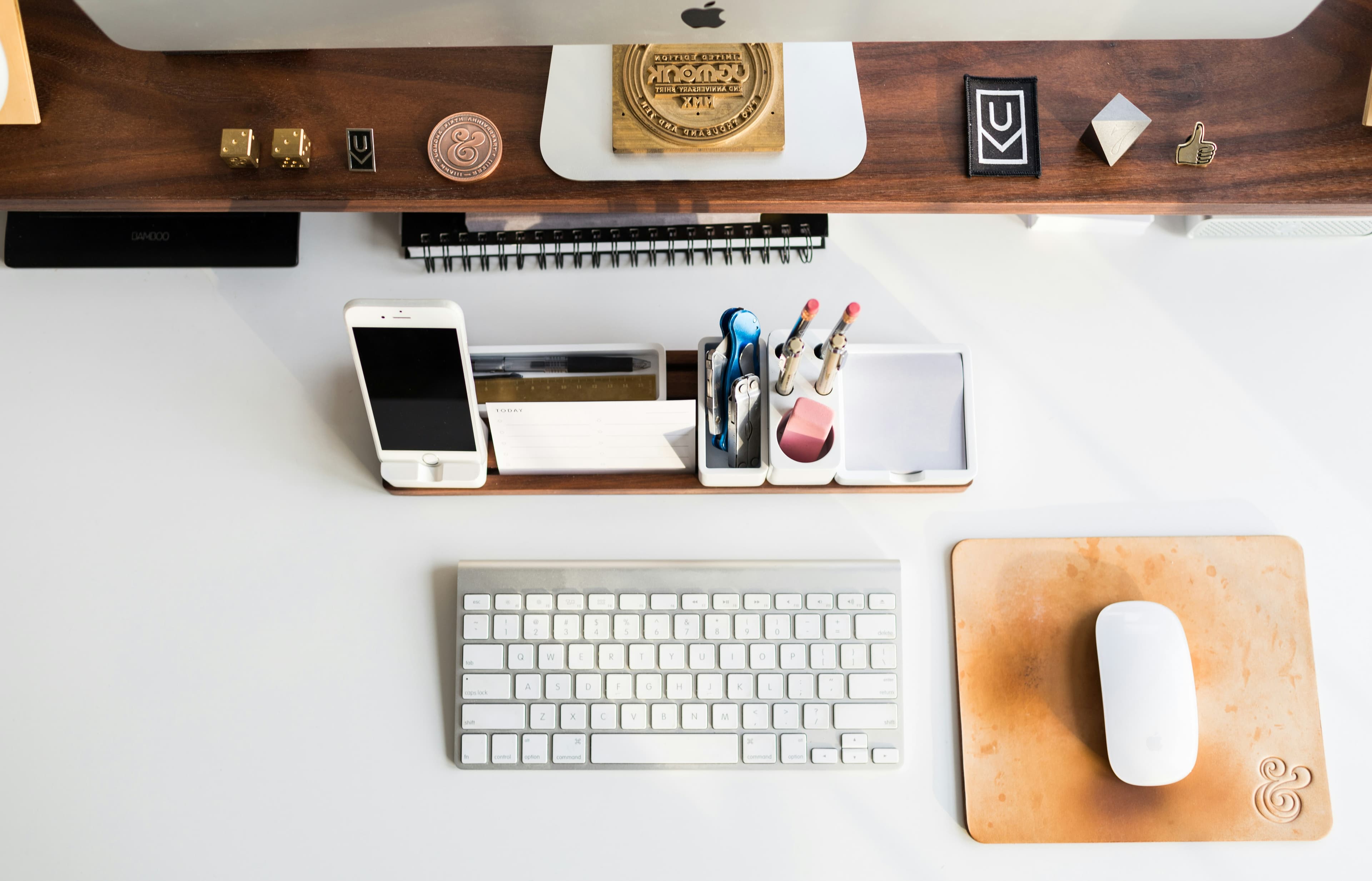 Neatly arranged stationery, notebooks, pens on bright desk, clean minimal product display